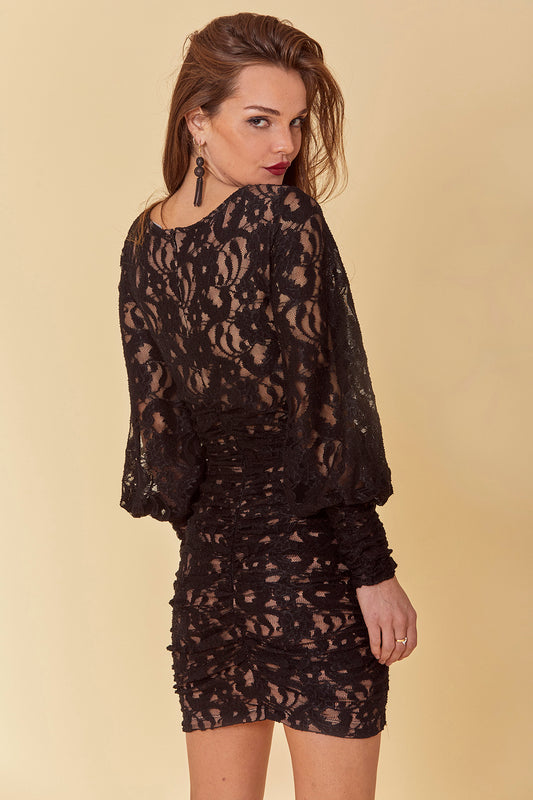 Lace fitted mini dress with long, oversized Victorian sleeves, V-neck and all over ruching with lacy black overlay and nude knit body.