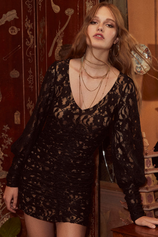 Lace fitted mini dress with long, oversized Victorian sleeves, V-neck and all over ruching with lacy black overlay and nude knit body.